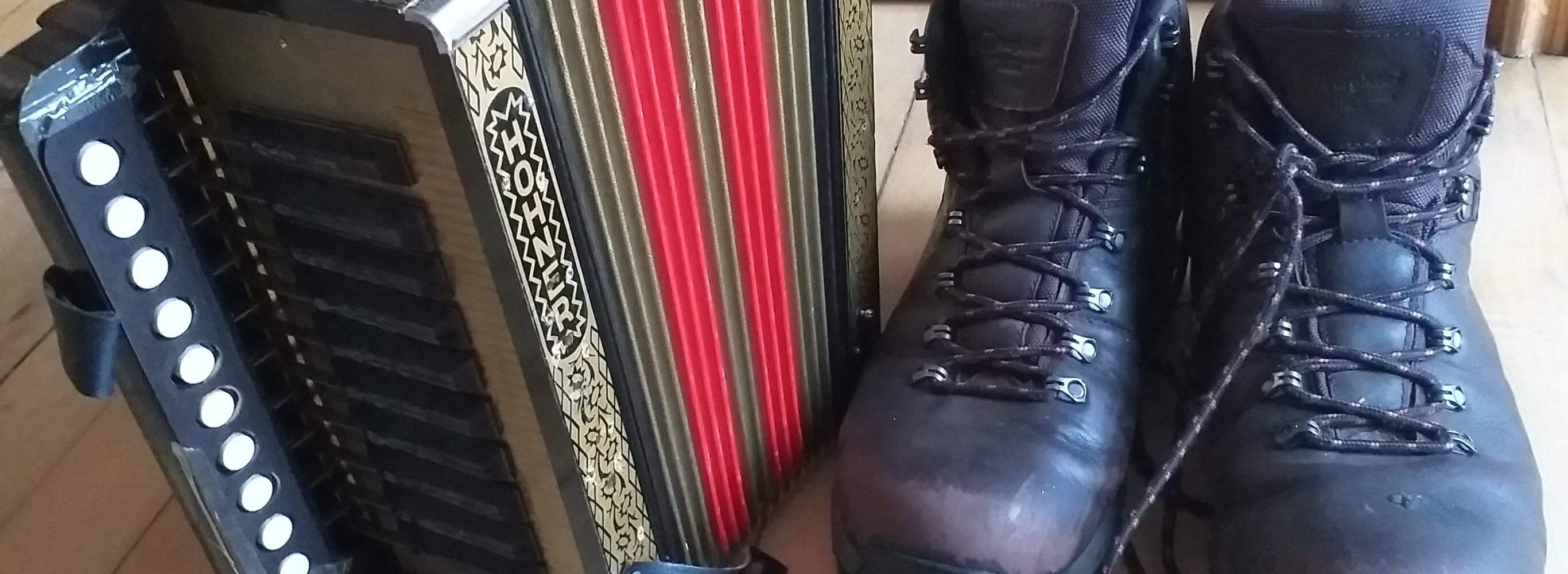 Accordion and a pair of walking boots